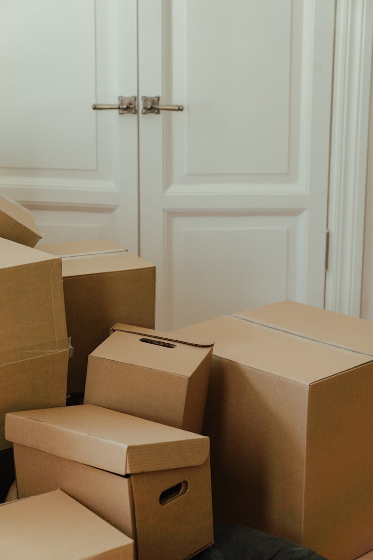 Brown Cardboard Box on White Wooden Door